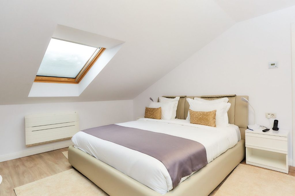 Executive Loft King room with king bed under a sloping ceiling