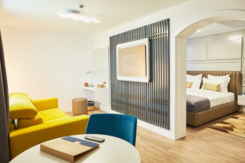 Junior Suite with king bed, seating area and slatted feature wall