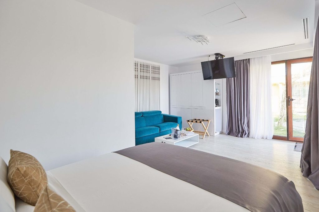 Treehouse interior with king bed and blue sofa