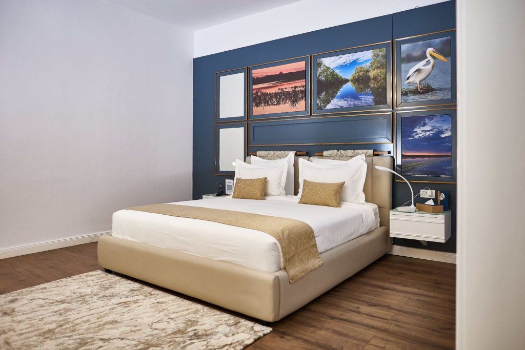 VIP Garden Suite bedroom with king bed and Danube Delta artwork